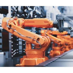 industrial automation - orange robotic arm on factory floor
